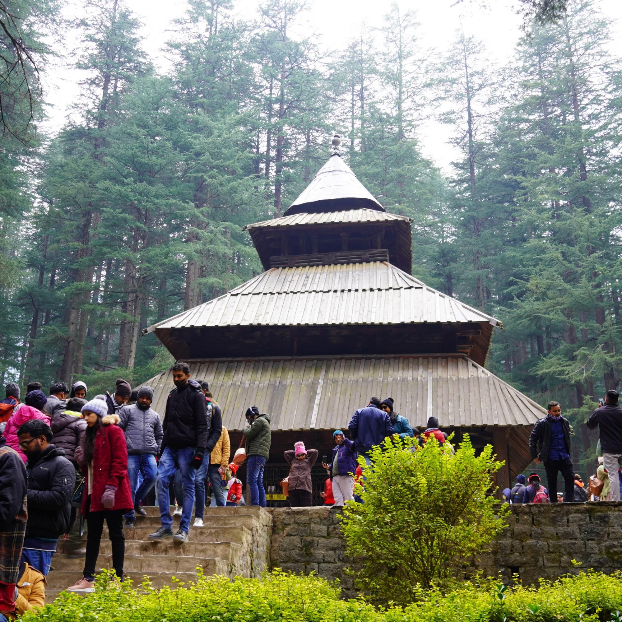 Hadimba Temple in Manali with visitors on the compound steps