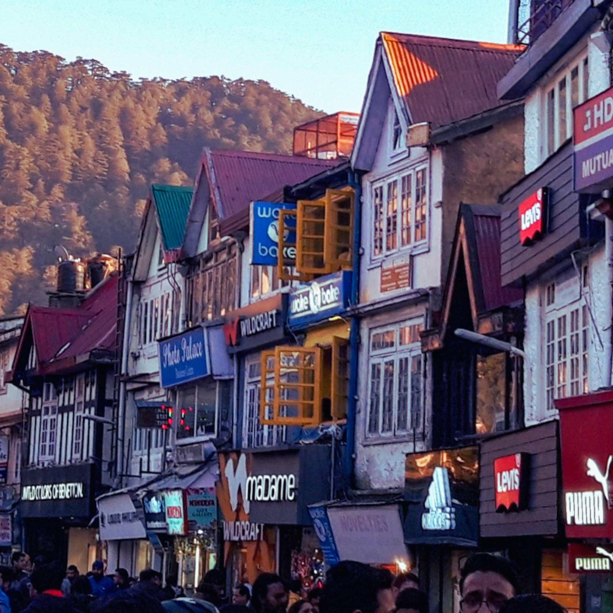 Street view of Mall Road Shimla with people walking and shops on both sides