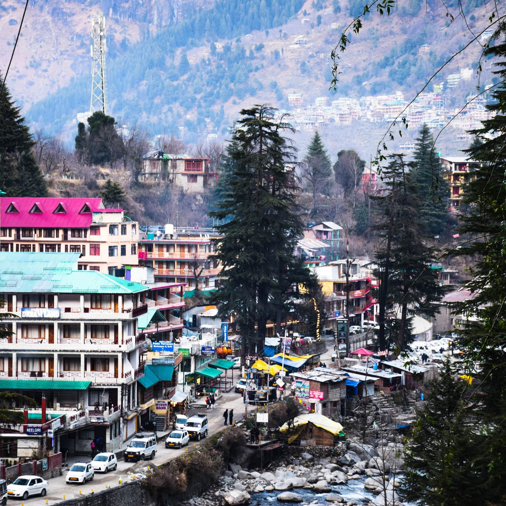 Narrow lane in Old Manali with cafes and mountain views