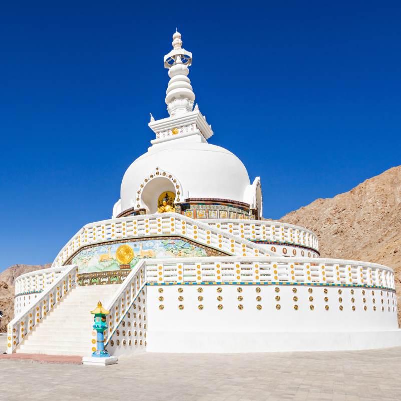 The white dome of Shanti Stupa glowing in afternoon sunlight
