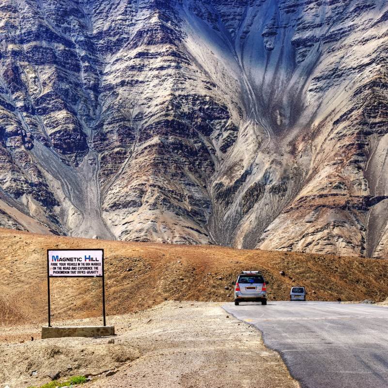 The marked road at Magnetic Hill near Leh where vehicles appear to roll uphill on their own