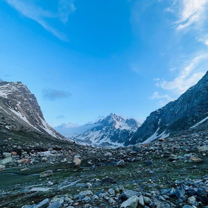 Panoramic view from the top of Hampta Pass showing the contrast between green Kullu and barren Lahaul valleys