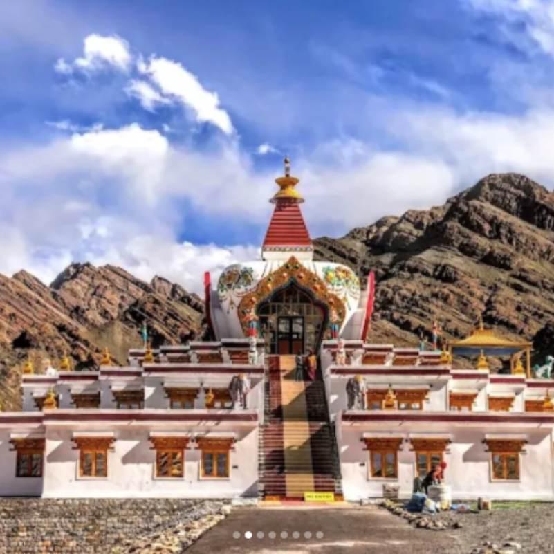 Sunlit Hemis Monastery buildings against the dry ridgeline of the Hemis gorge