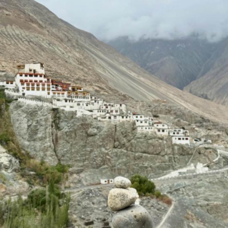 Whitewashed terraces and prayer halls of Diskit Monastery stacked up the hillside in classic Tibetan Gelugpa style