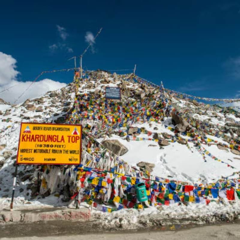 The winding road climbing to Khardung La pass between dry ridges of the Ladakh Range, the classic approach from Leh
