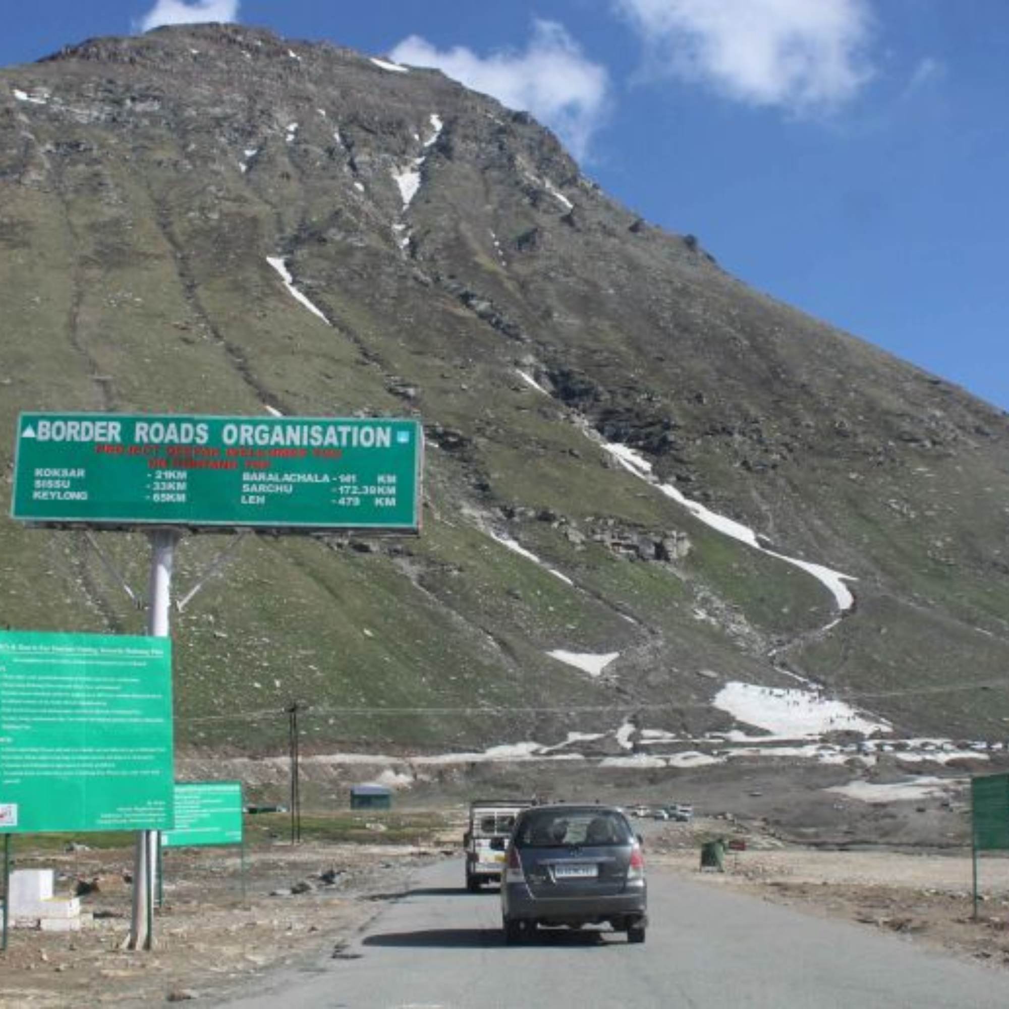 Rohtang Pass high altitude road with snow covered mountains and switchbacks in Himachal Pradesh