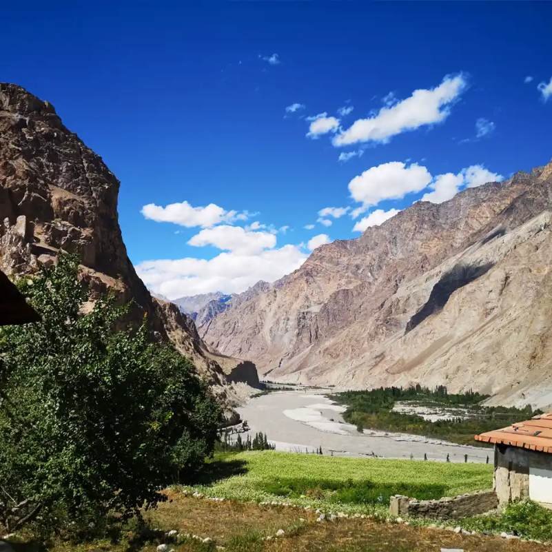 Turtuk Village in Ladakh with stone houses against a backdrop of rugged Karakoram mountains