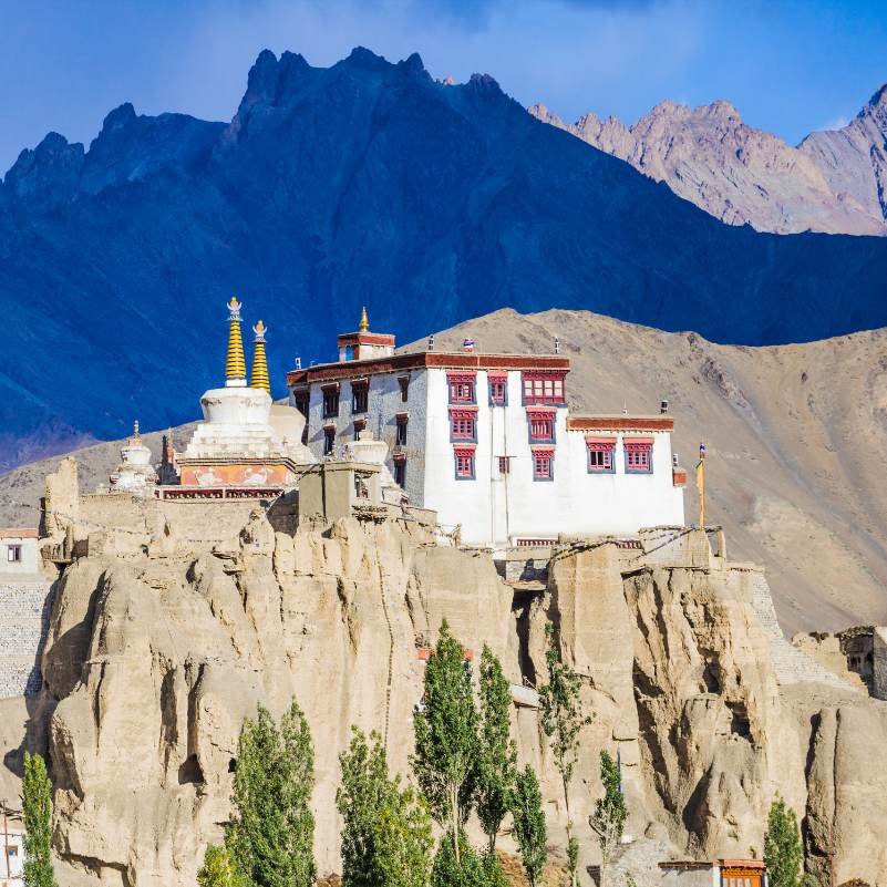 Panoramic view of Lamayuru Monastery perched above the village with barren mountains behind