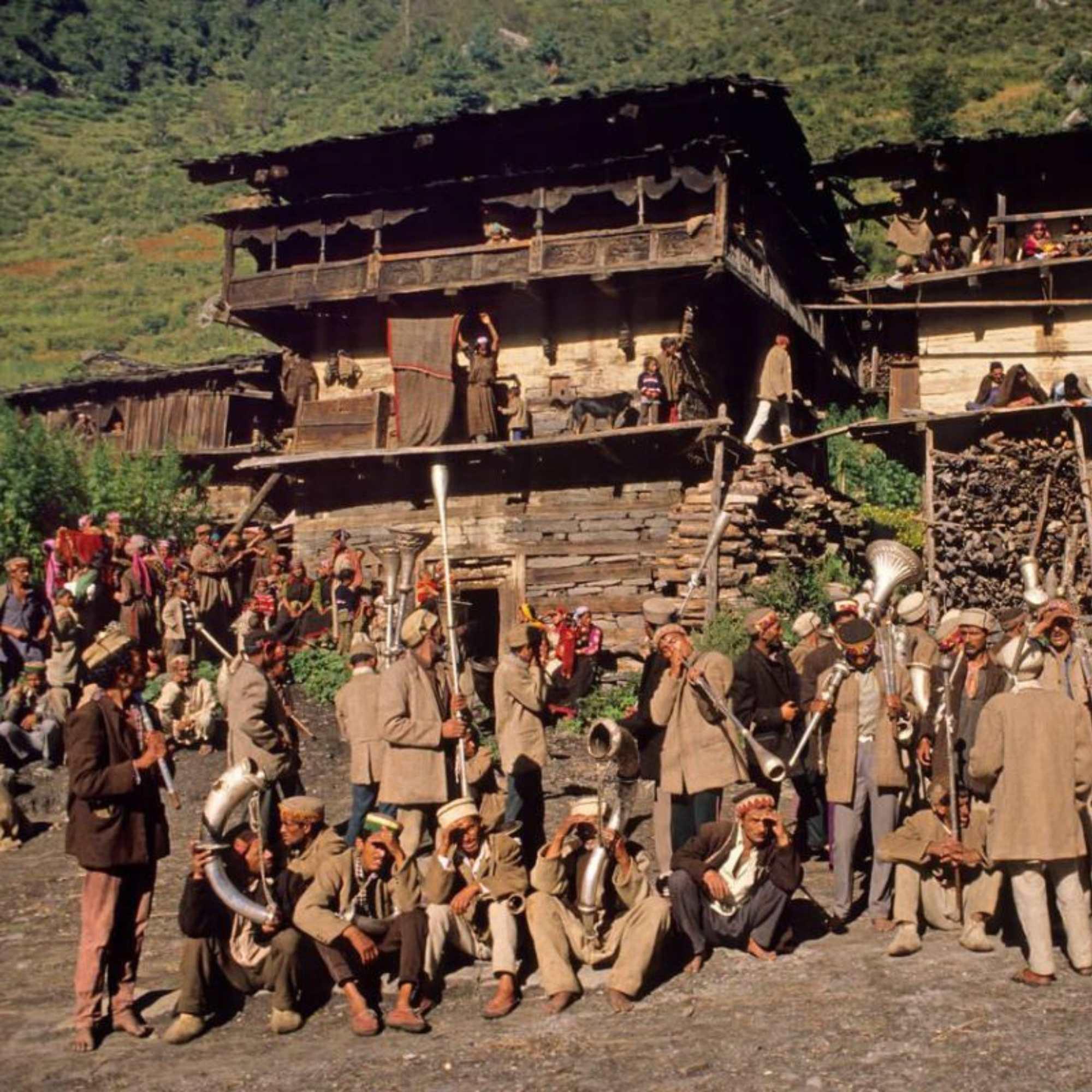 Scenic landscape of Malana Village surrounded by lush green valleys and snow-capped Himalayan peaks.jpg